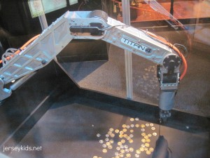 Try your hand at picking up coins using a robotic arm. Copyright Deborah Abrams Kaplan